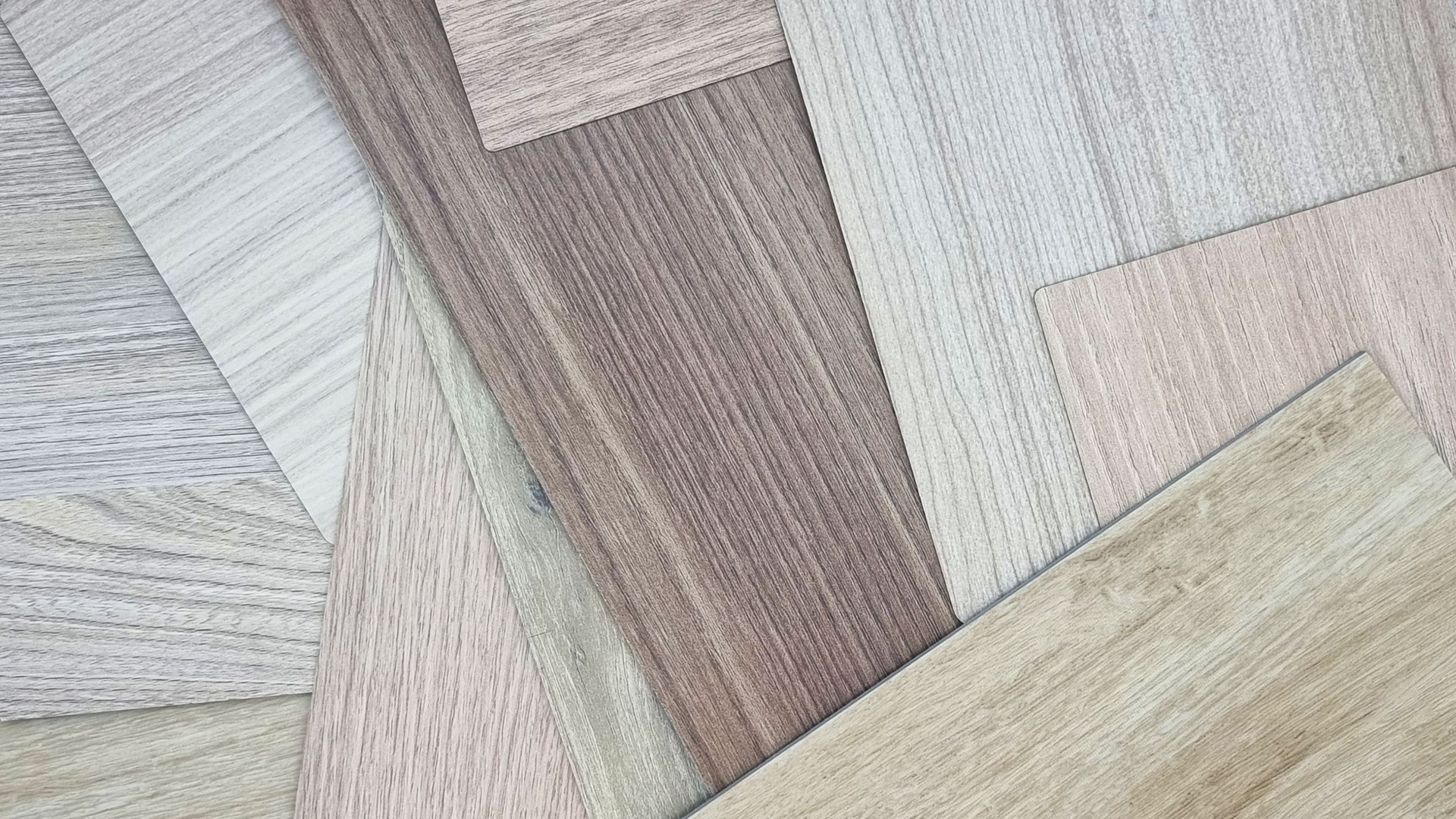 random place of multi texture of wooden interior material samples in light brown tone for minimal design including oak laminateds, walnut veneers, oak vinyl floorings (focused at wood grain texture).